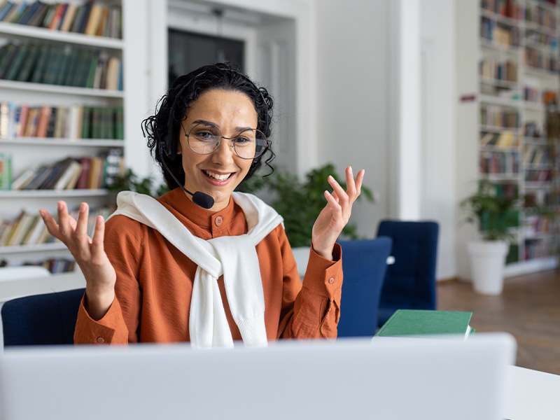 person sitting at a desk with books studying for grade nine